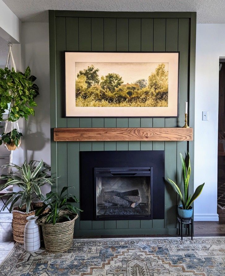 Vertical shiplap fireplace with wood mantel.